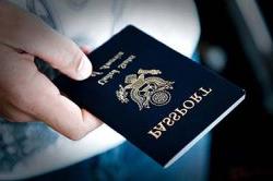 Close-up of hand holding passport.